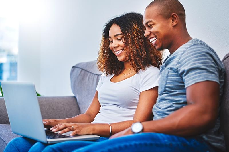 Smiling woman looking at laptop